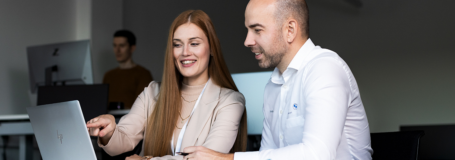 The picture shows three happy BMW employees returning to the office from their lunch break.