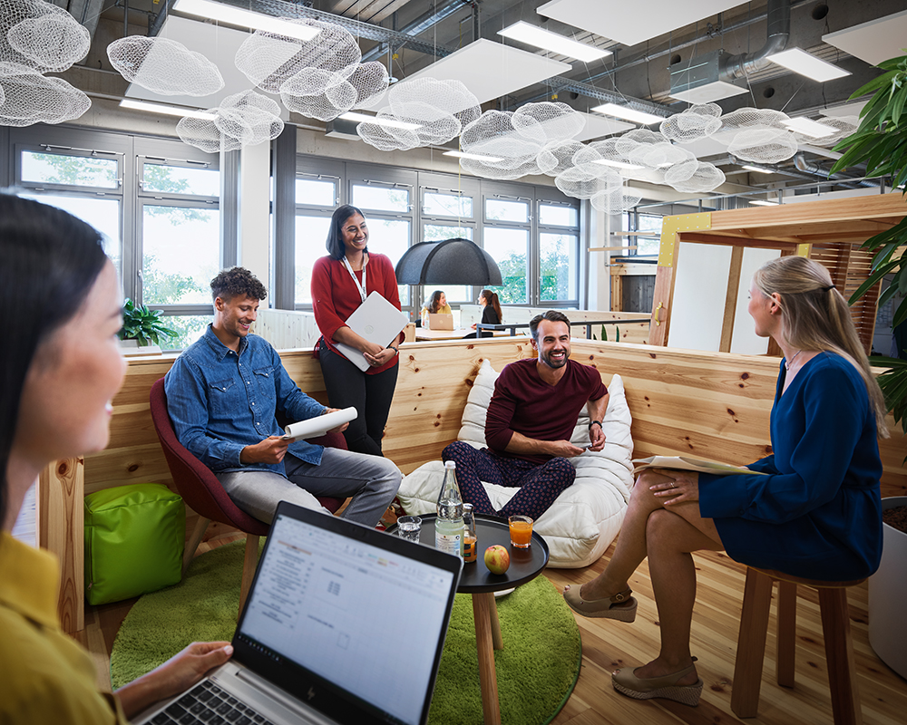 A group of students having a conversation in a modern office environment
