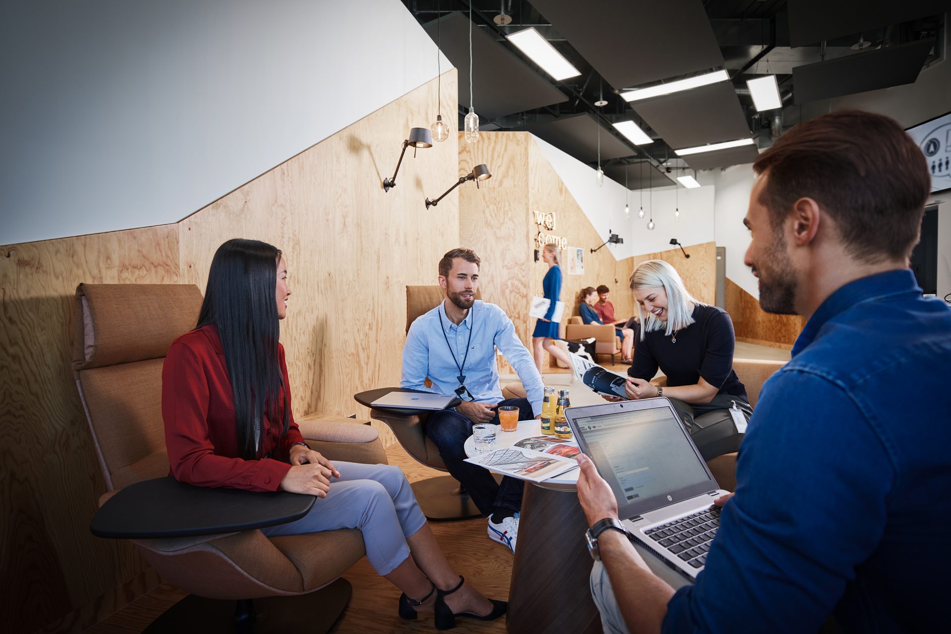 A group of sutdents having a fun conversation in an innovative office environment.