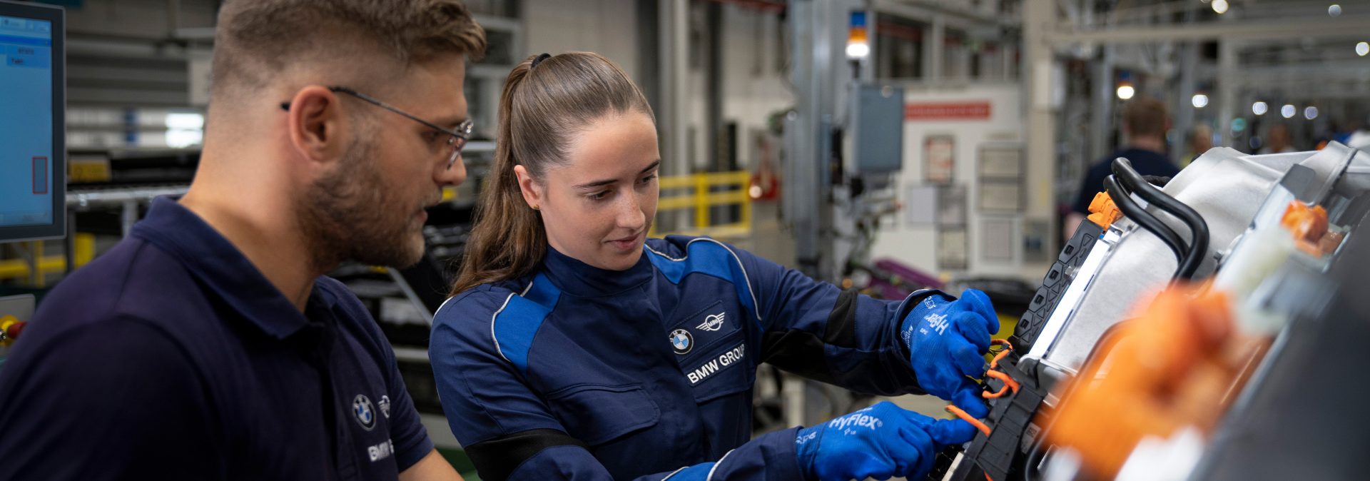 A BMW Group technical apprentice and teacher at work.