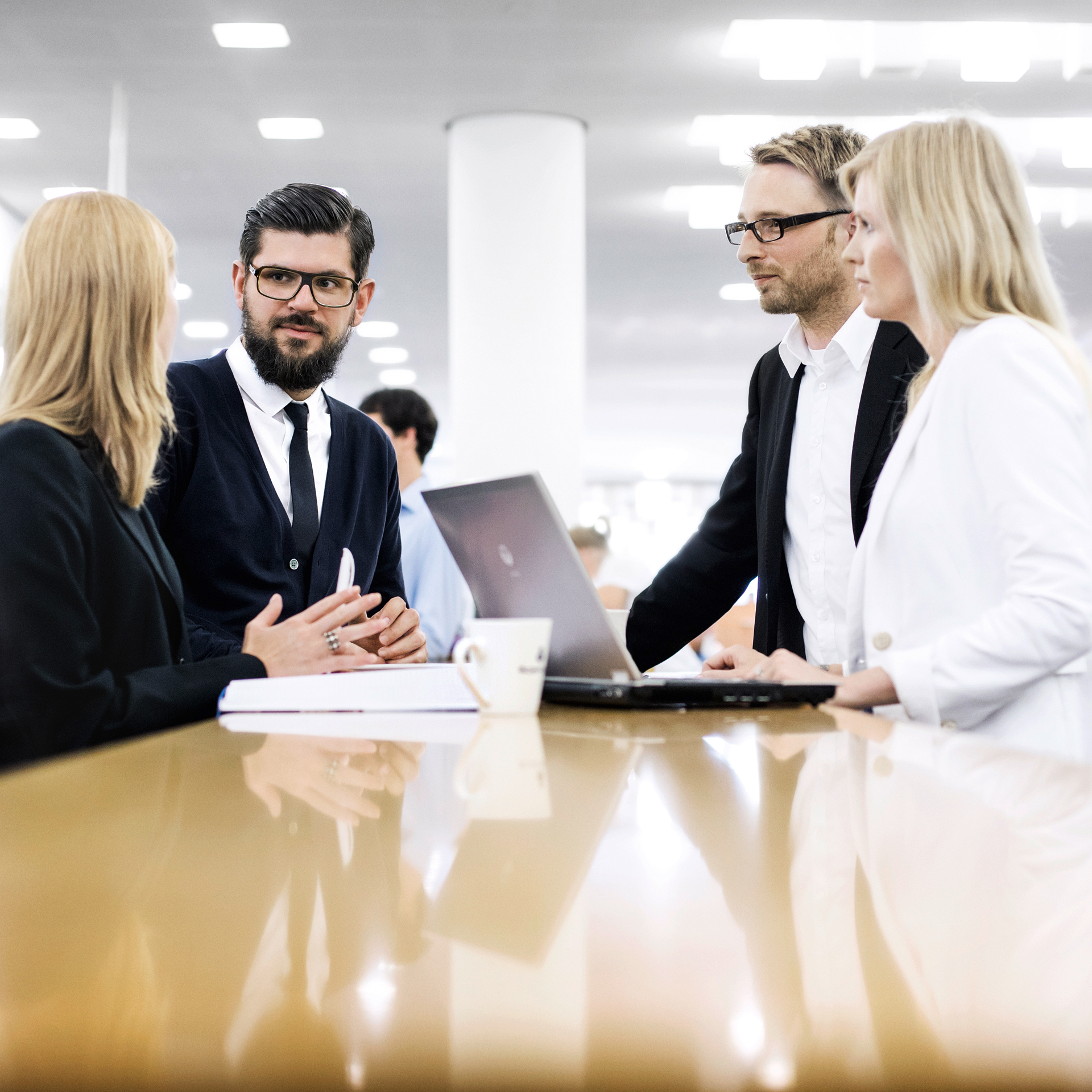 The picture shows the meeting of four BMW employees representing corporate strategy jobs. 