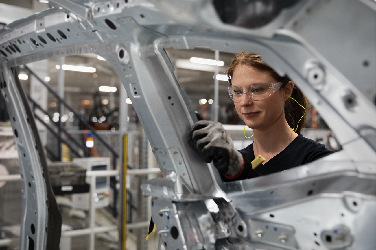 Bodyshop worker with a car body