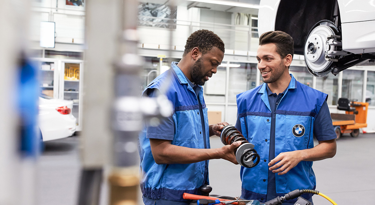 The picture represents the job culture by showing two BMW production employees.  