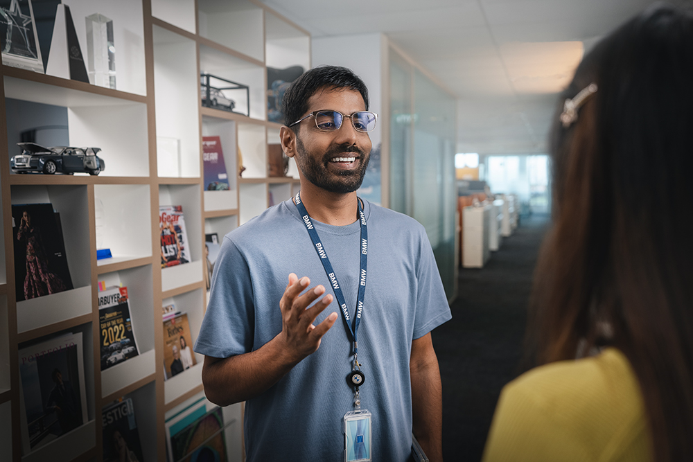 The picture shows two BMW Group employees talking.