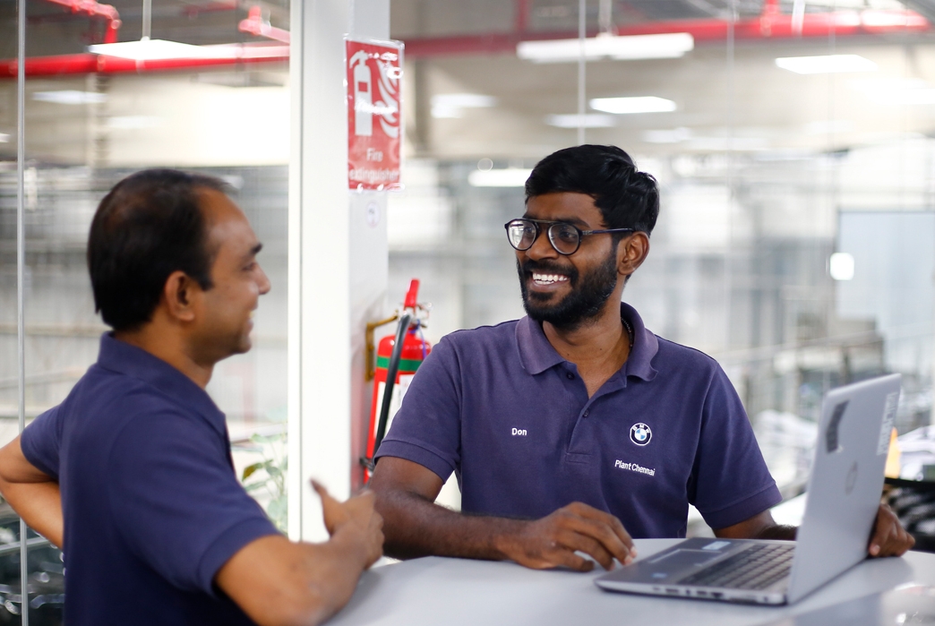 Two employees talking in meeting.