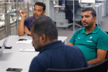 The picture shows a team meeting in the chennai production plant.