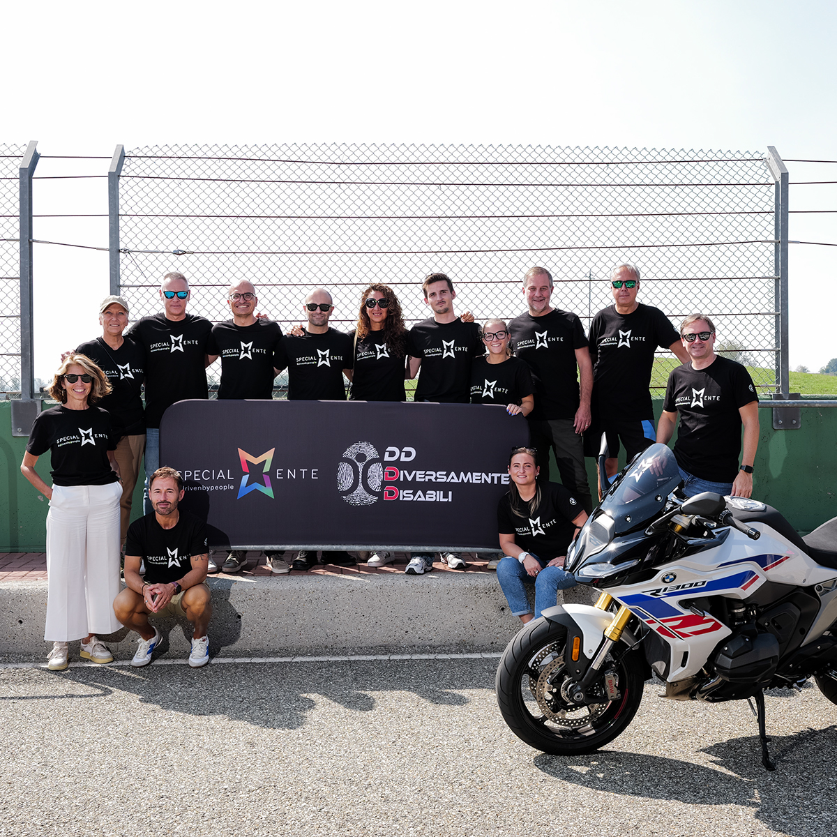 A disabled man is lifted onto a motorbike