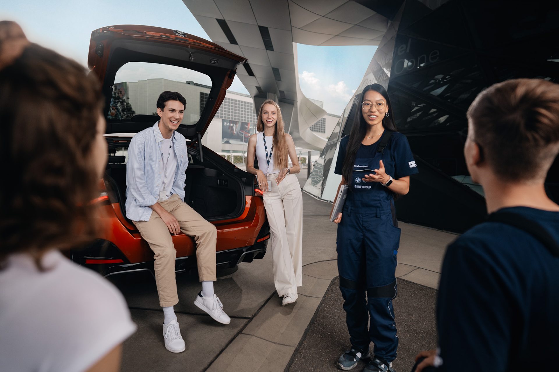 The picture shows a BMW employee joining an online meeting.
