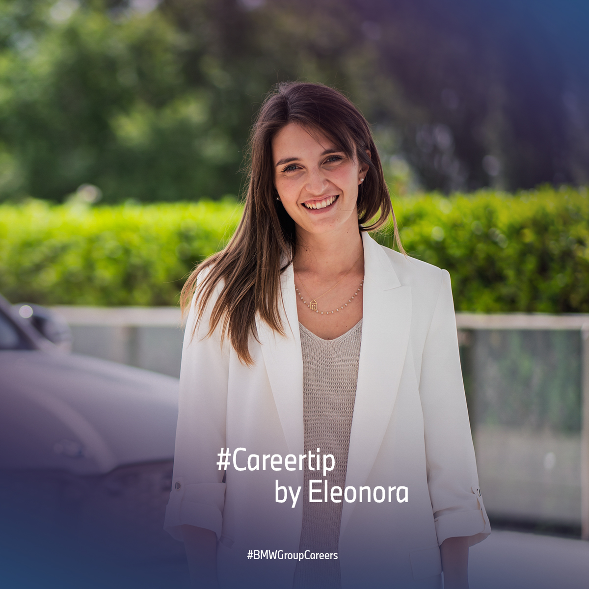 BMW Group employee Eleonora in front of a BMW iX