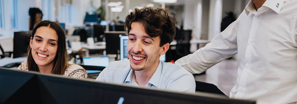 Three colleagues are having a chat with coffee