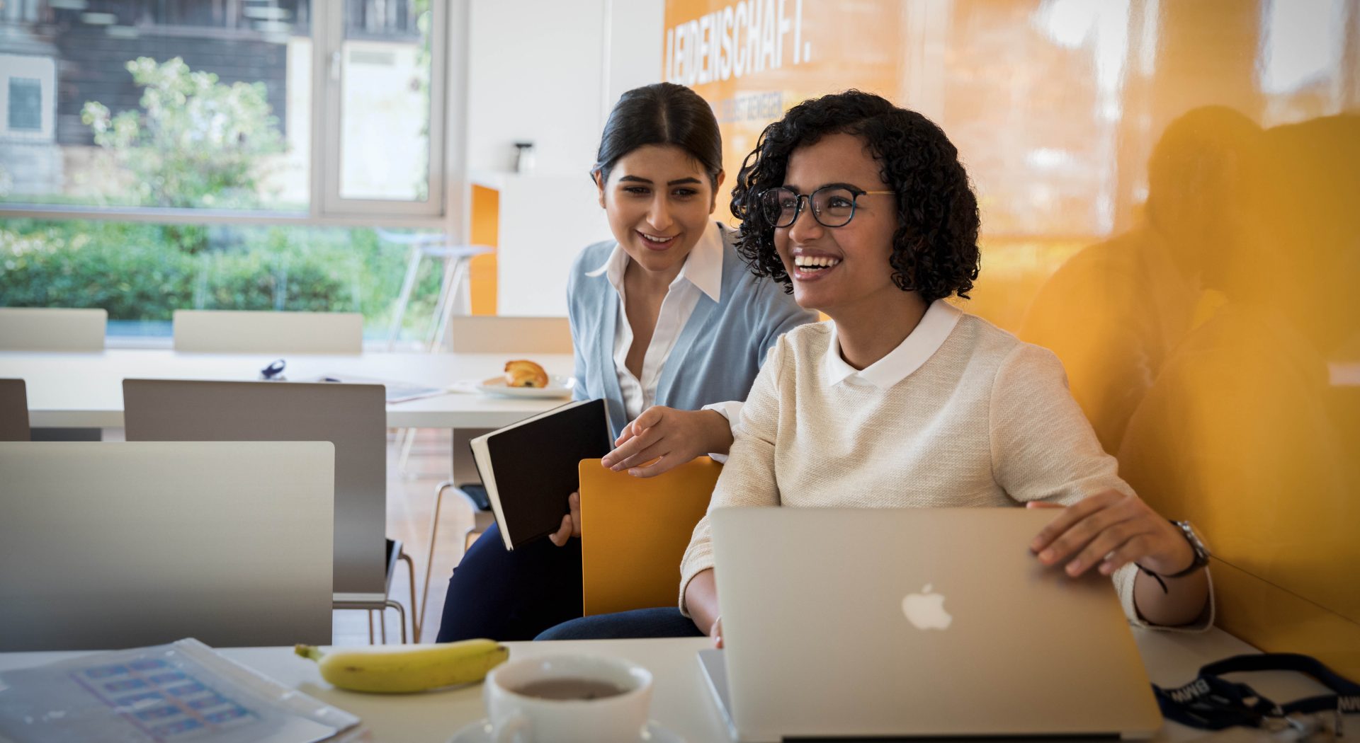 The picture represents the job culture by showing two employees having fun.