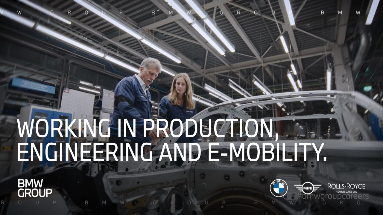 The picture shows BMW employees working in production.