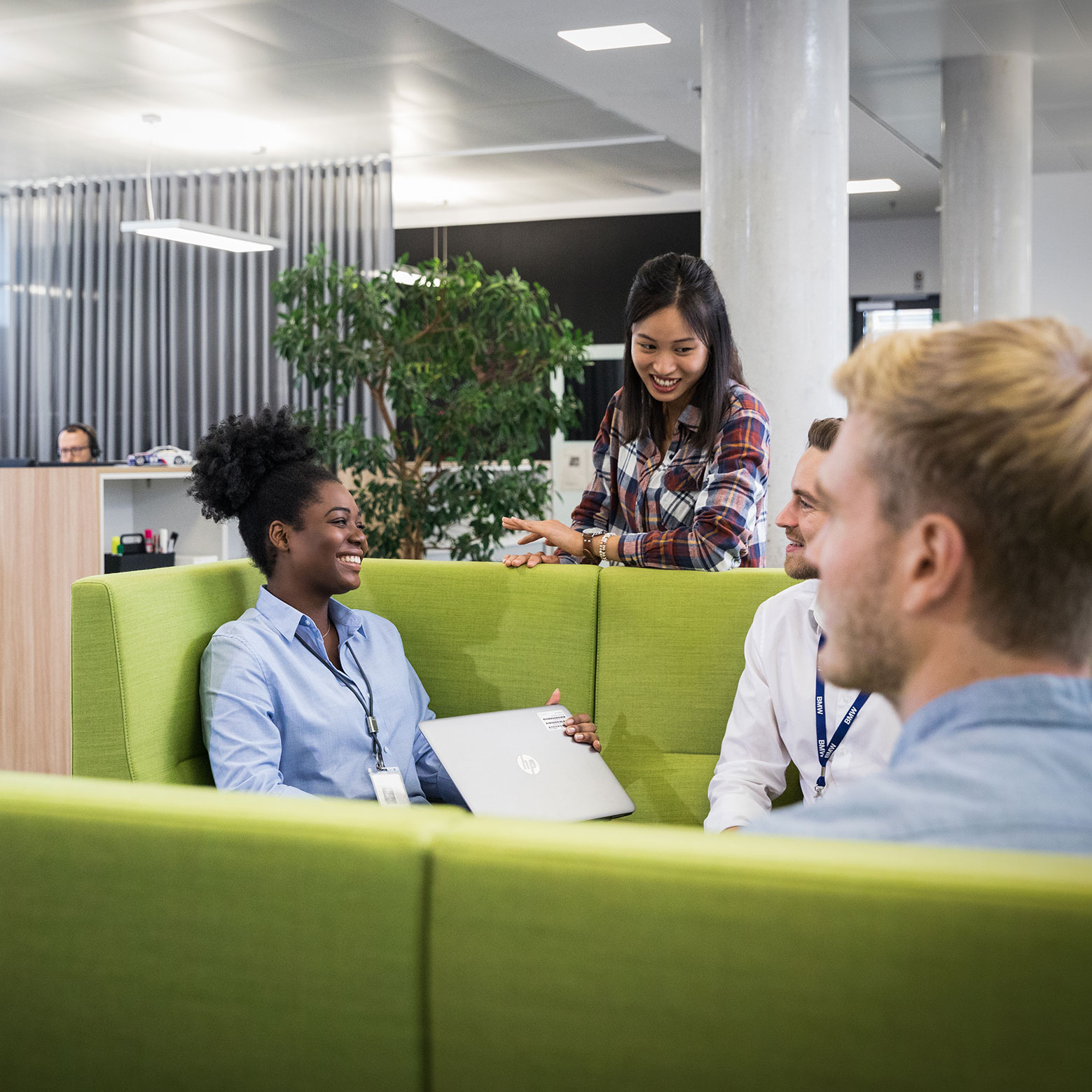 The image shows a group of employees in a meeting situation.