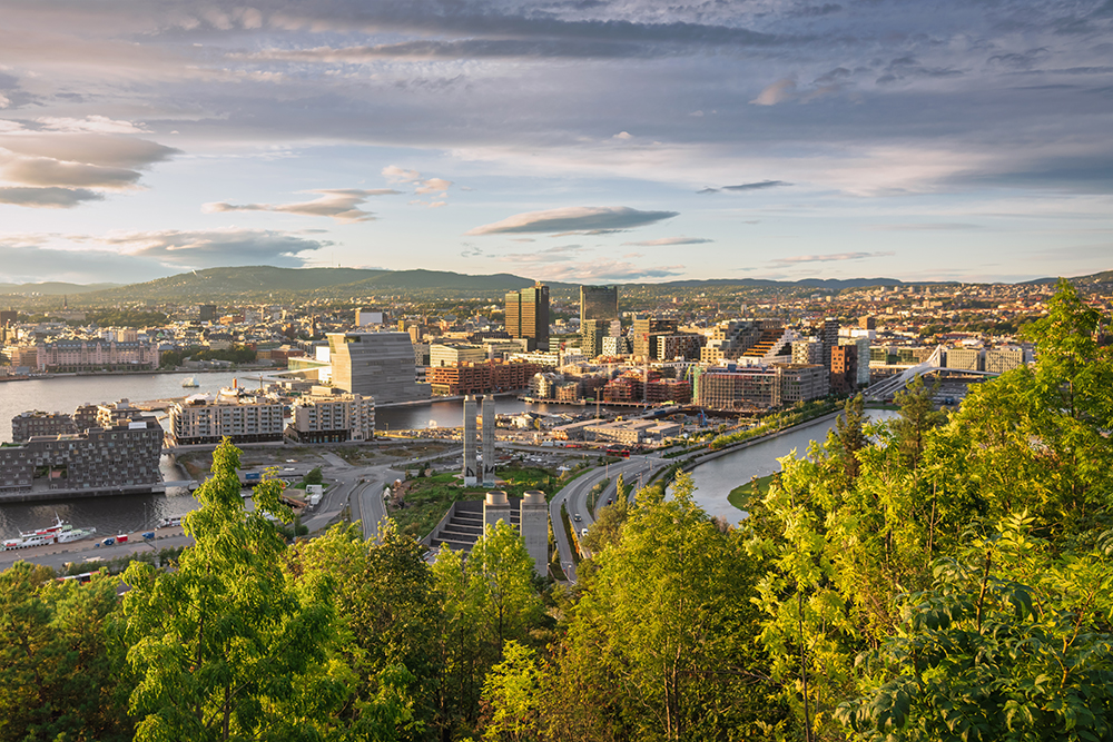 Sunset Panorama from above Ekebergparken over Sorenga District towards Oslo Cityscape with Oslo Harbor in late afternoon light close to sunset. Oslo City, Norway, Scandinavia, Northern Europe