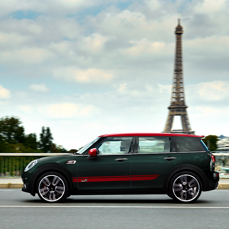 A MINI driving past the Eiffel Tower.