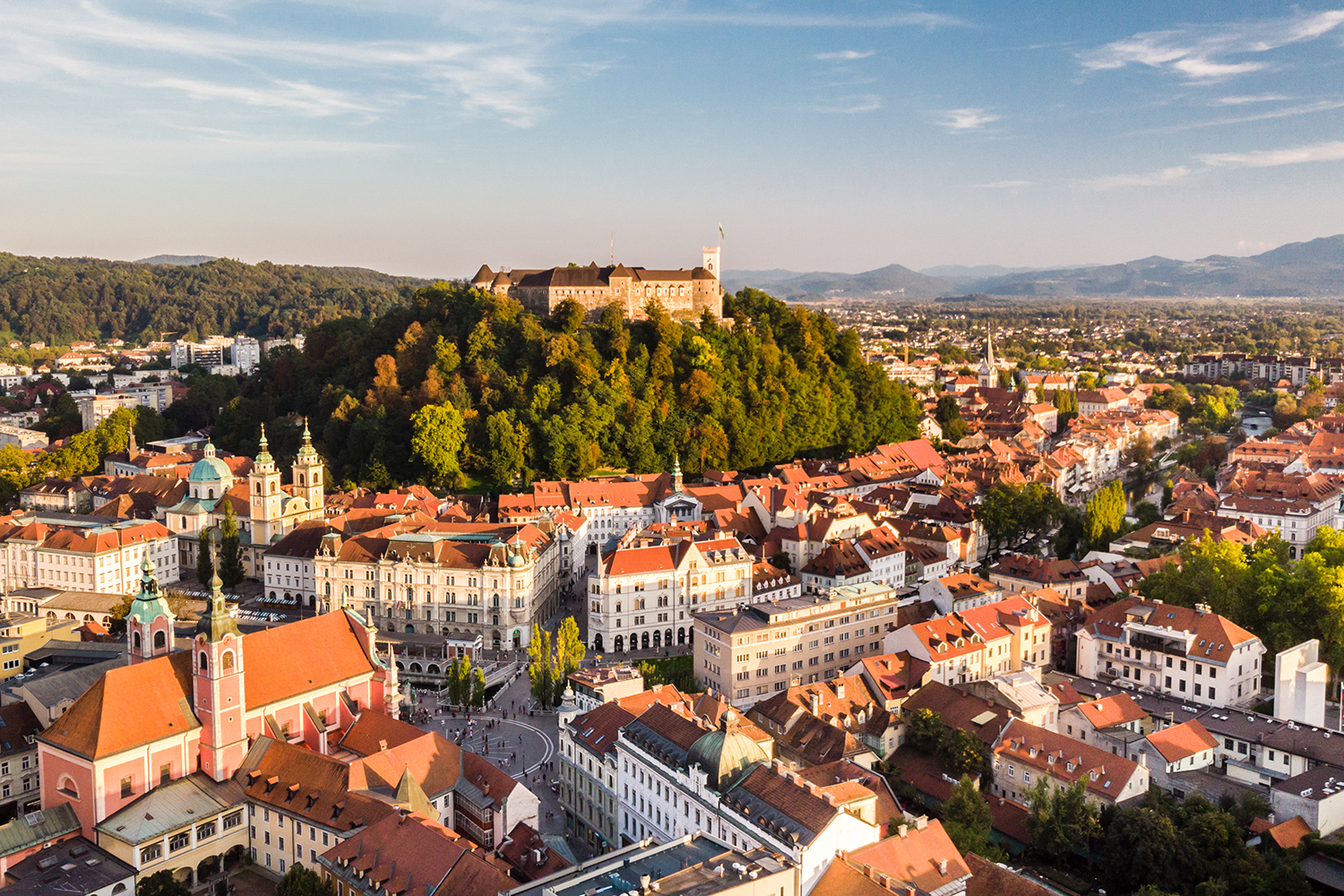 Aerial panoramic view of Ljubljana, capital of Slovenia in warm afternoon sun.