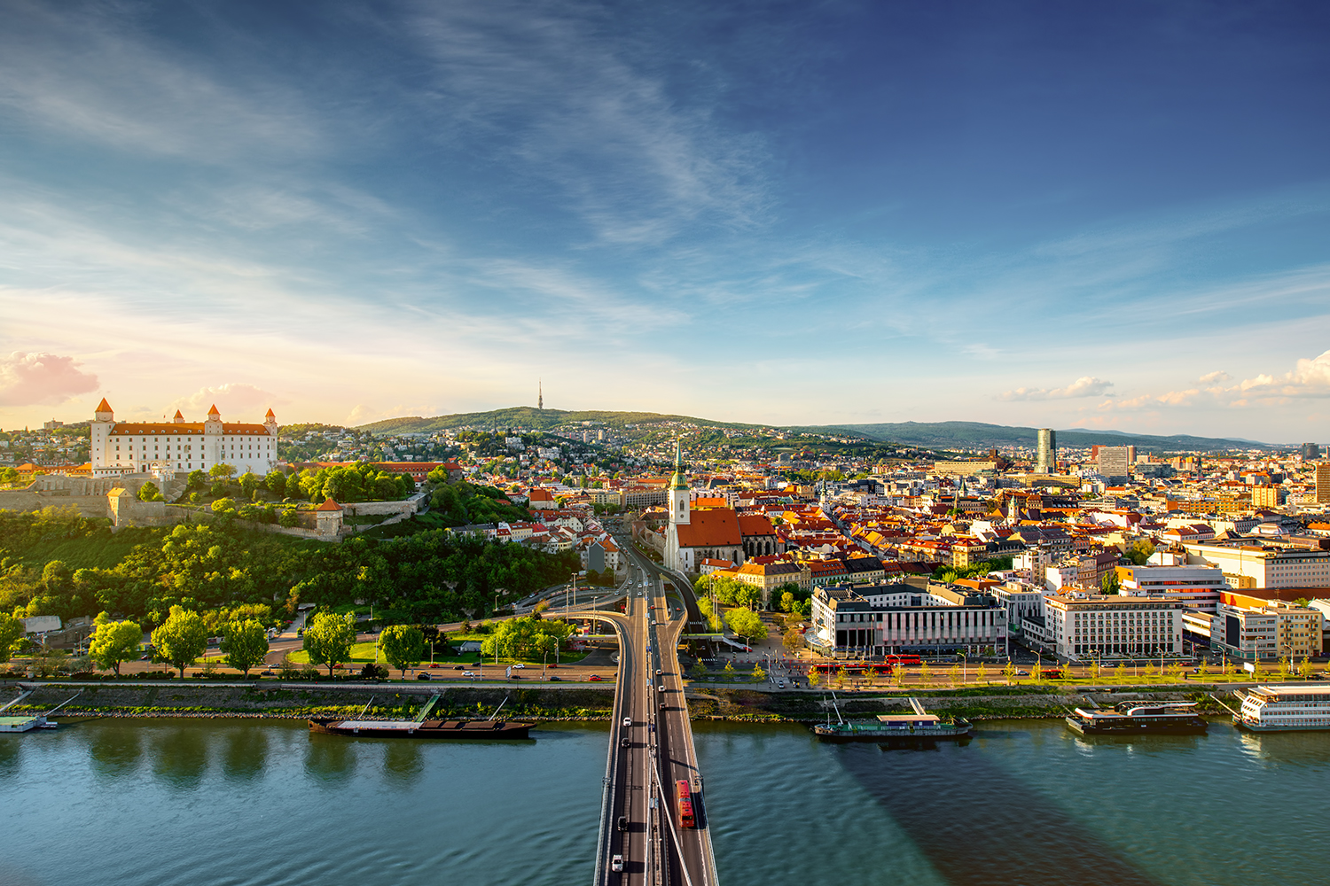 Bratislava aerial cityscape view on the old town with Saint Martin's cathedral, castle hill and Danube river on the sunset in Slovakia. Wide angle view with copy space