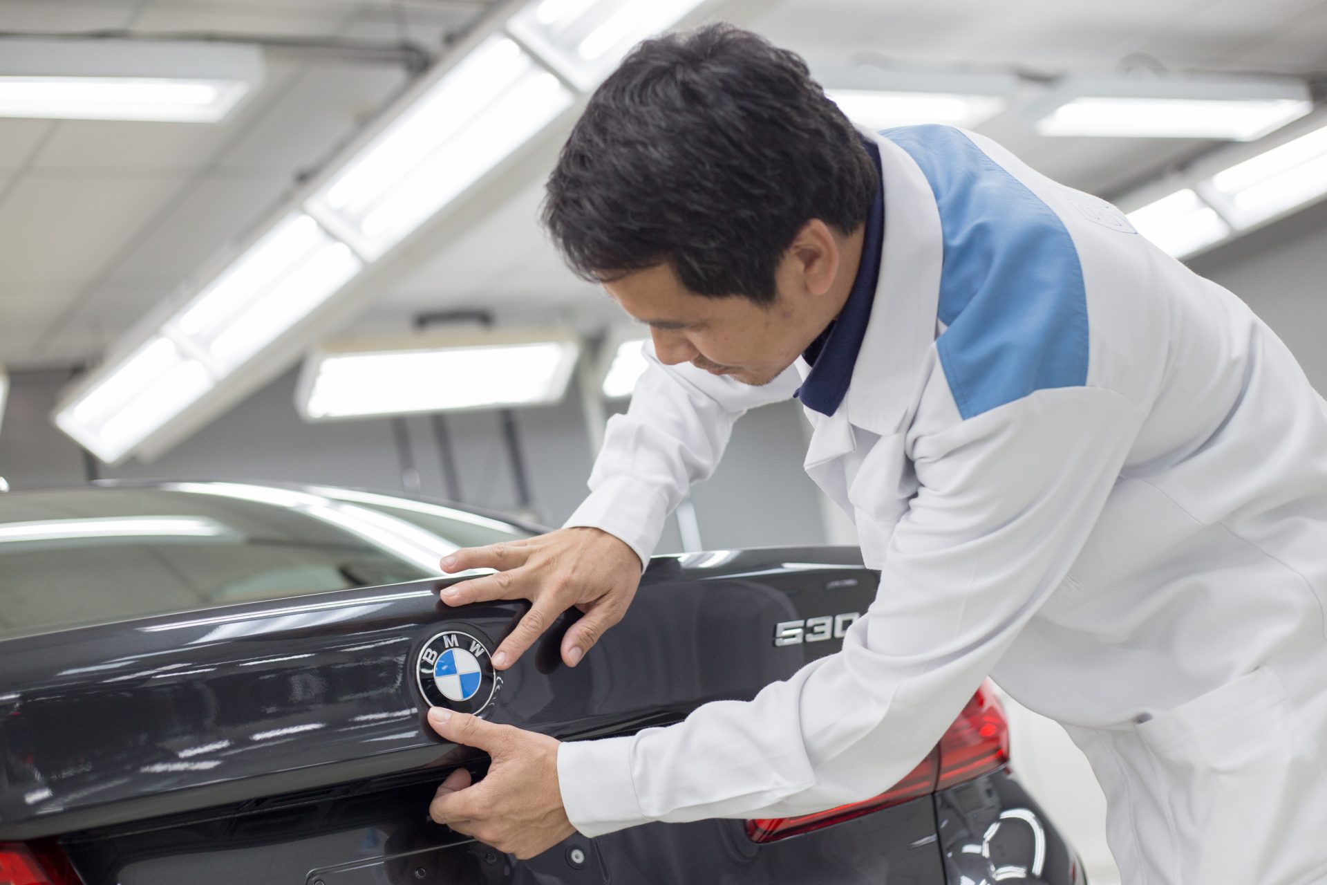 BMW employee checks quality of the BMW logo.