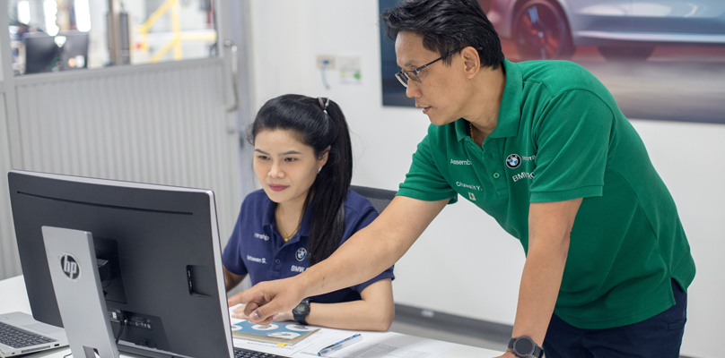 Female student with her trainer at a computer.