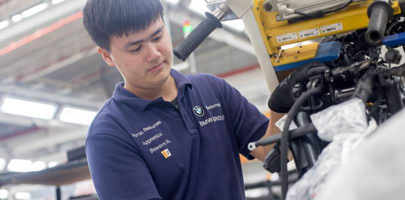 Apprentice working on an engine.