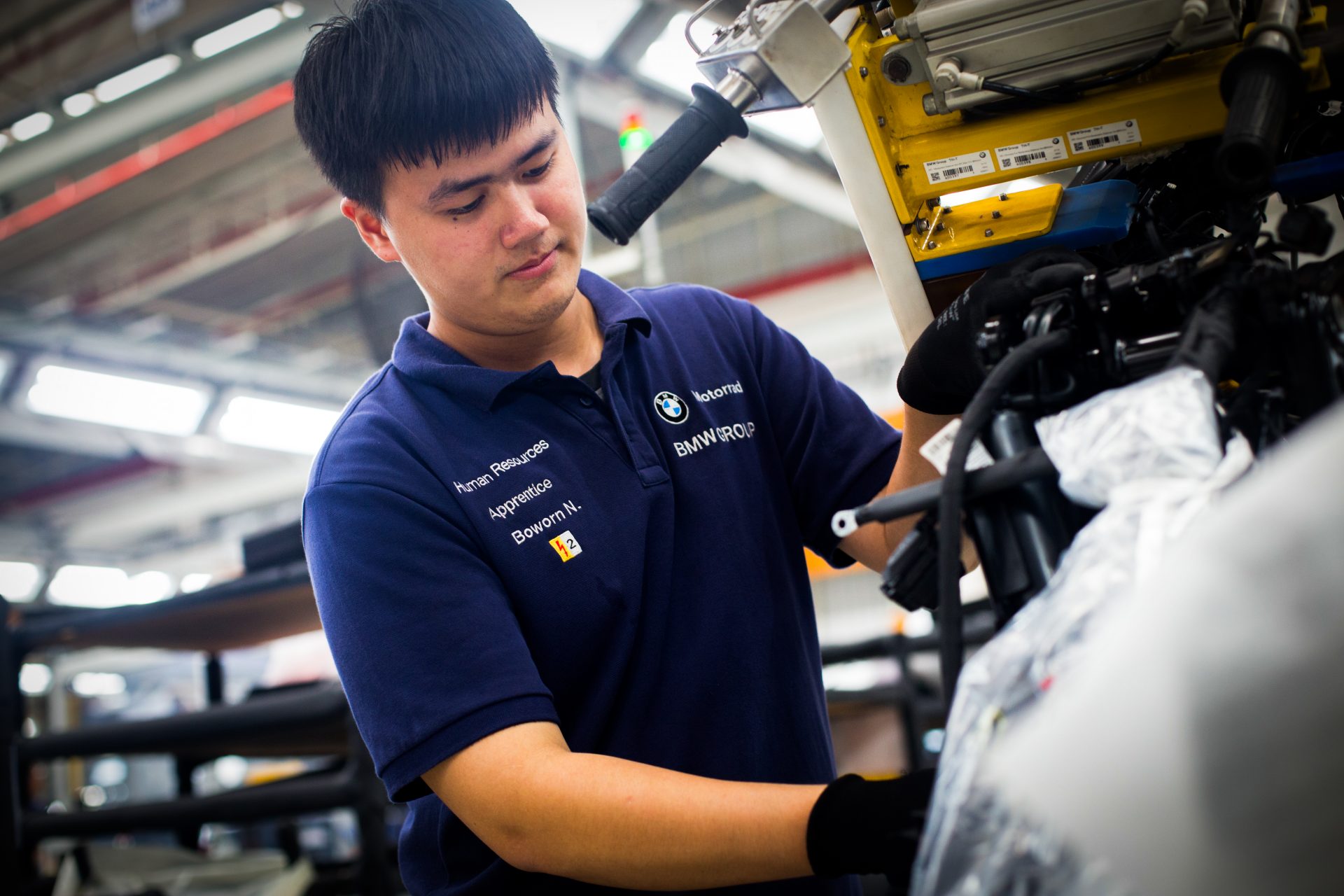 Apprentice working on an engine.