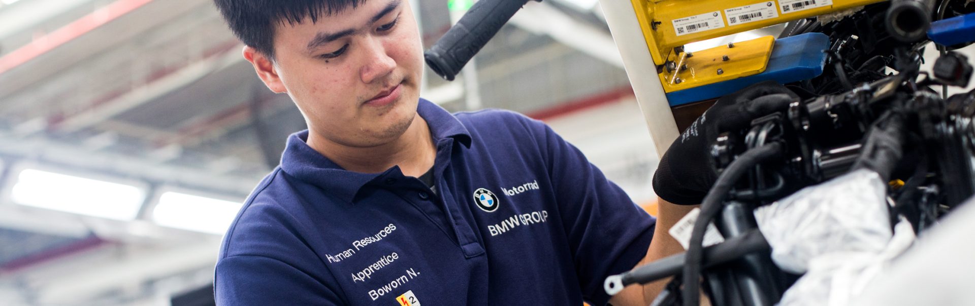Apprentice working on engine