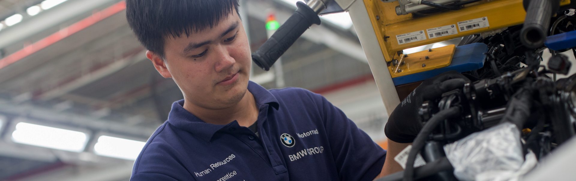 Apprentice working on engine