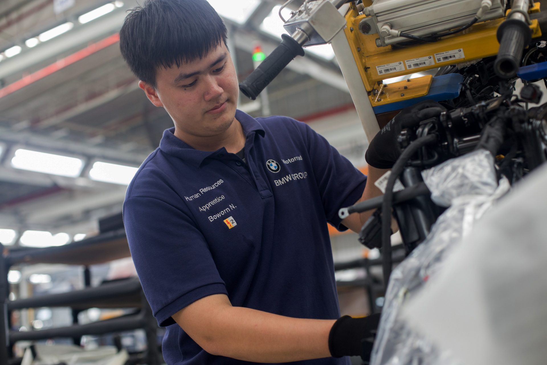 Apprentice working on engine