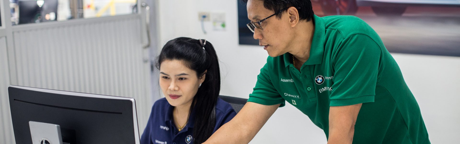 Student working with trainer on computer.