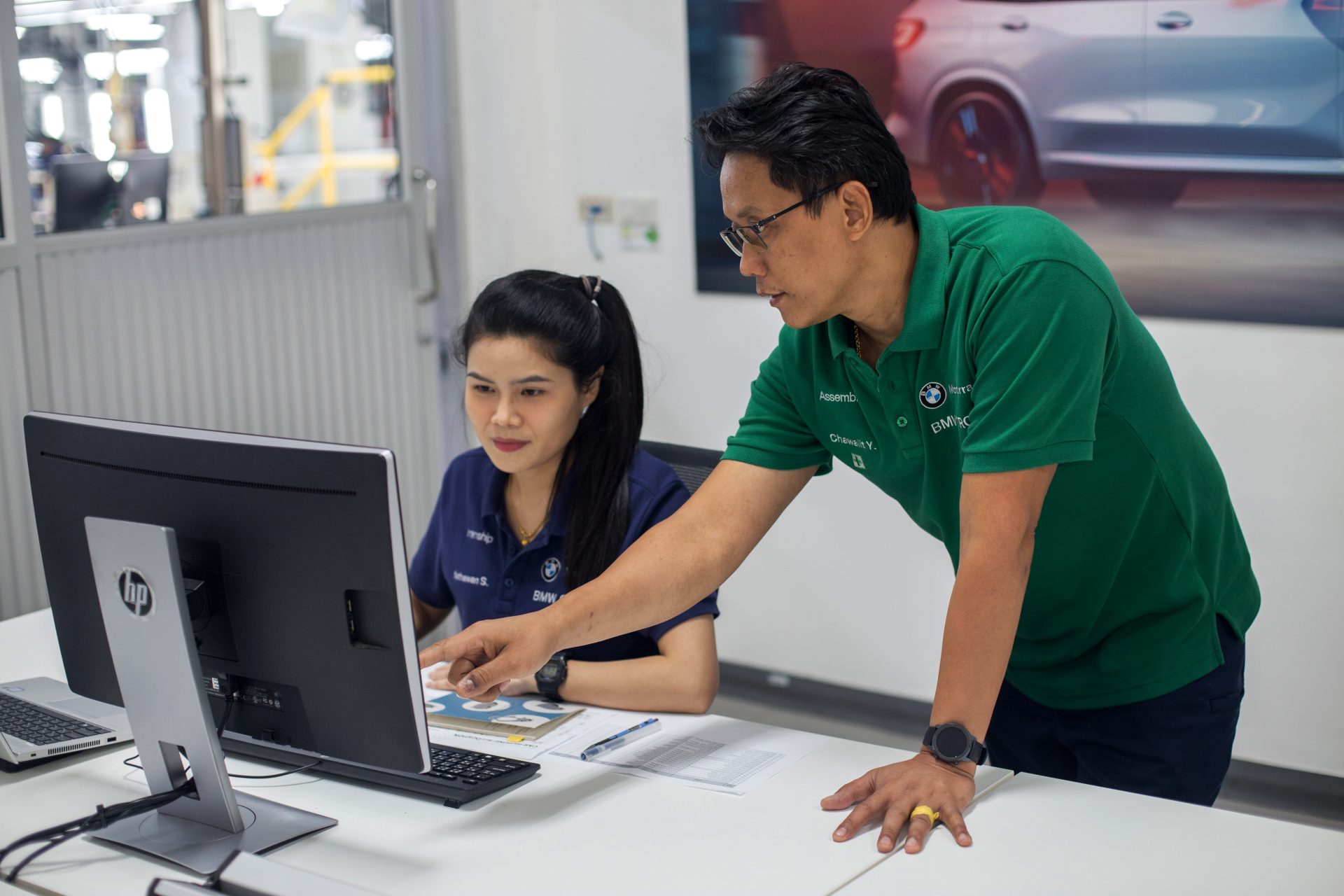 Student working with trainer on computer.