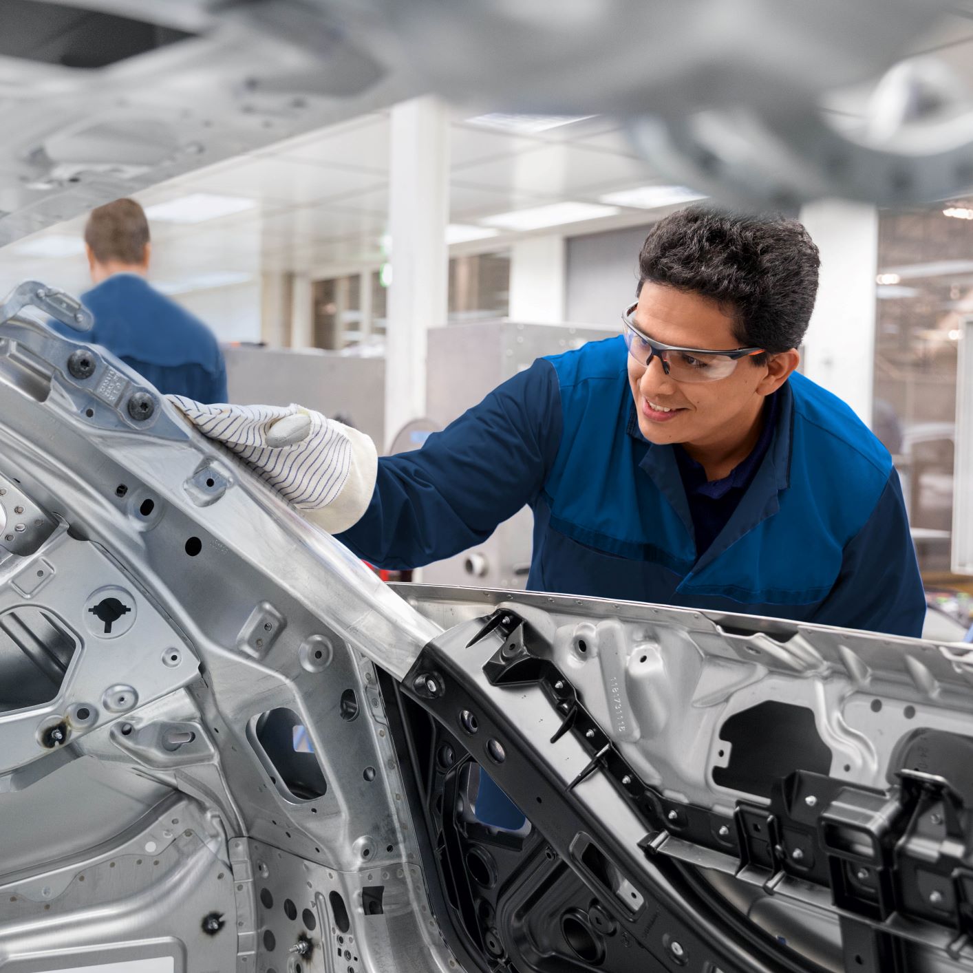 A quality worker checks a car at BMW.