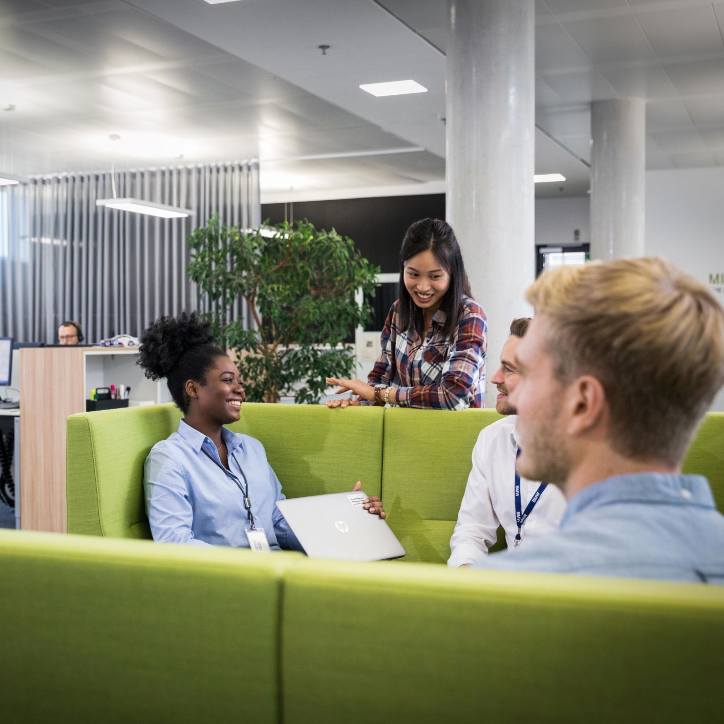 Two women and two men are planning are having a conversation about human resources at BMW.