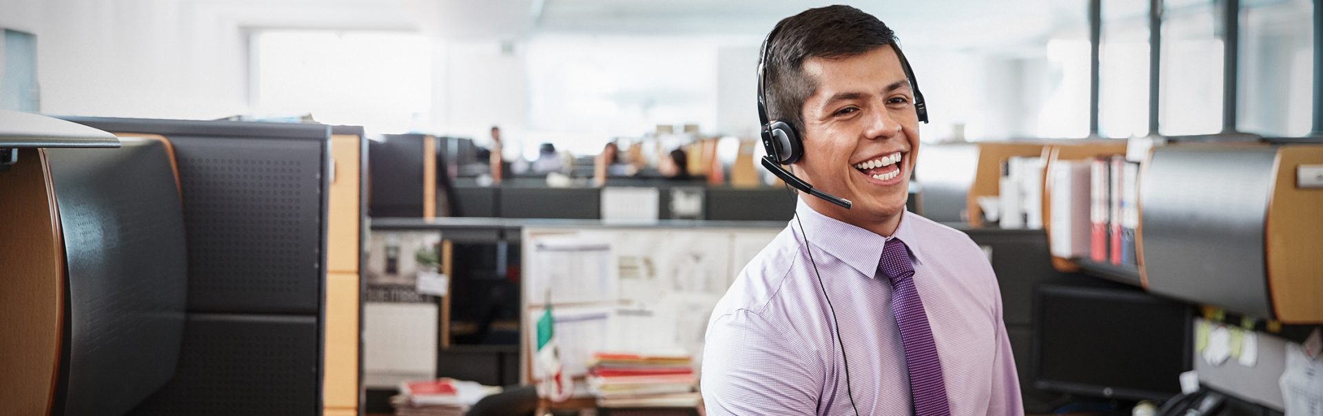 A customer services employee is talking to a customer via phone.
