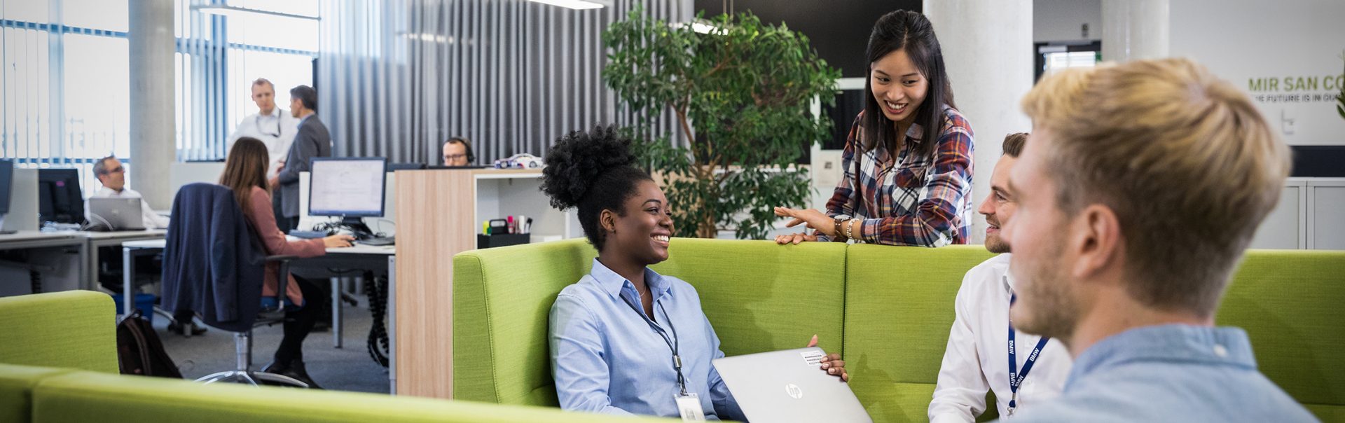 A group of students having a conversation in a modern office environment