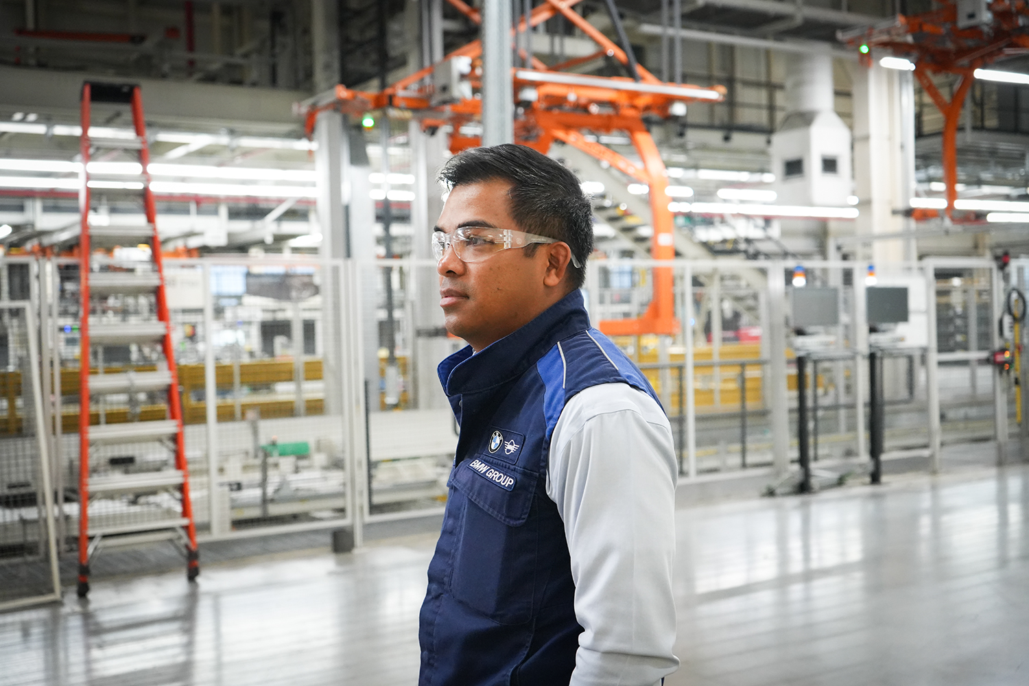 BMW Group Maintenance team lead Pip walking through the production hall
