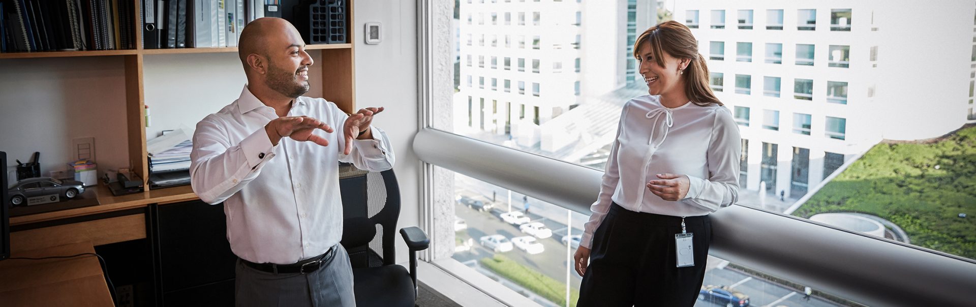 Two Marketing colleagues in the office talking about their work.