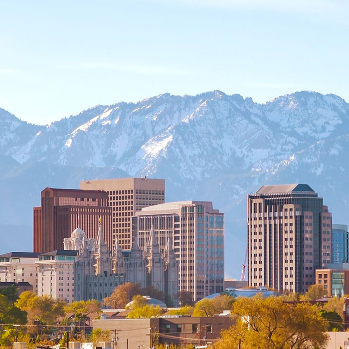 The picture shows Salt Lake City against a backdrop of snow-capped mountains.