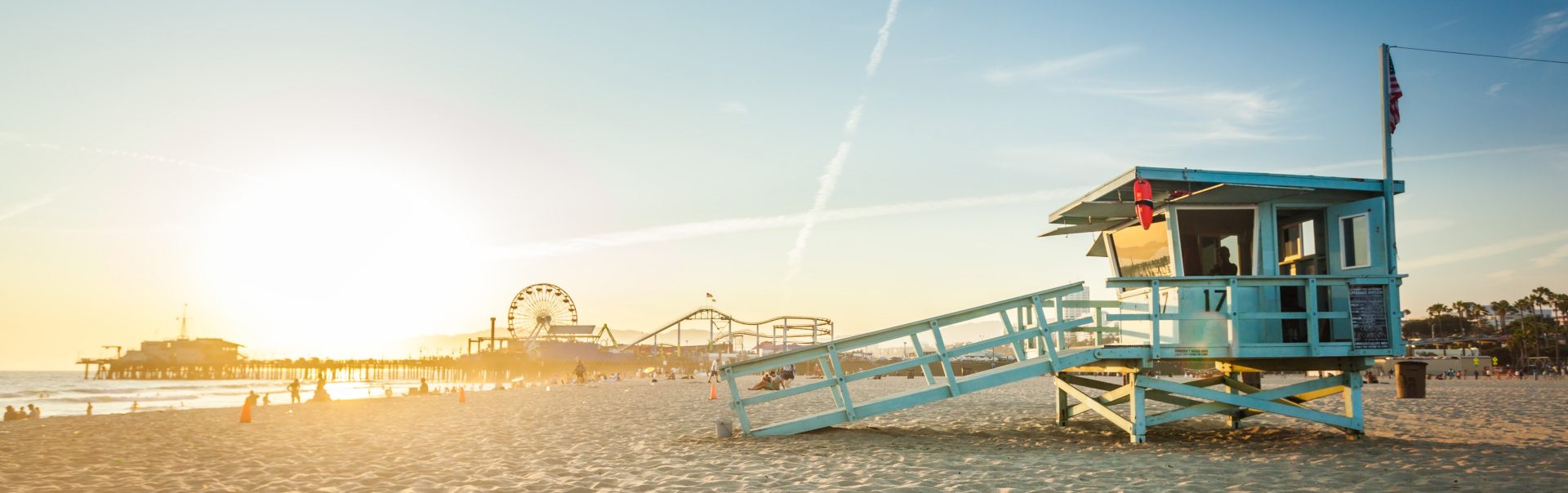 Sunset on Santa Monica beach with rescue cabin and amusement park on the background