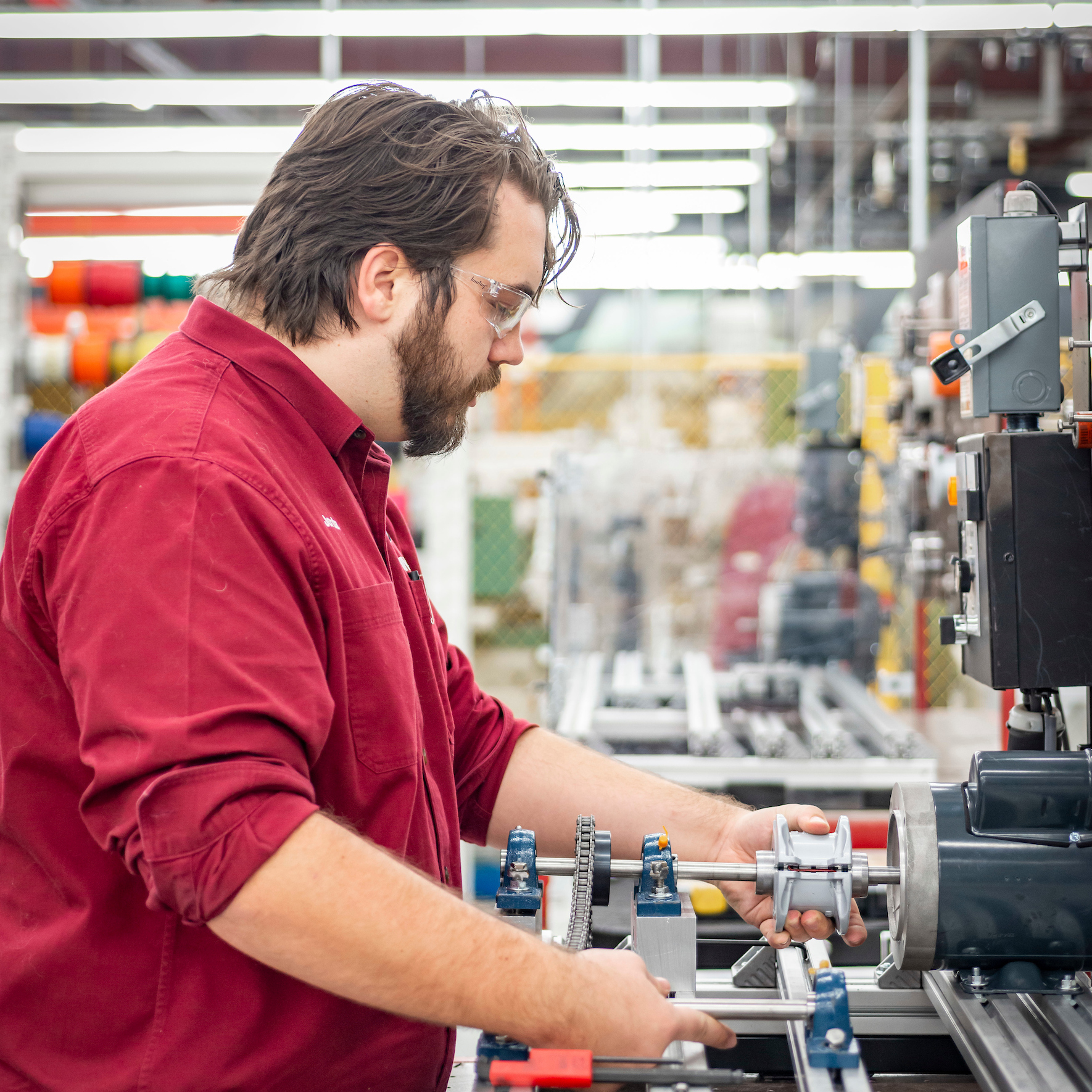 A Rising Scholar Participant working with a machine