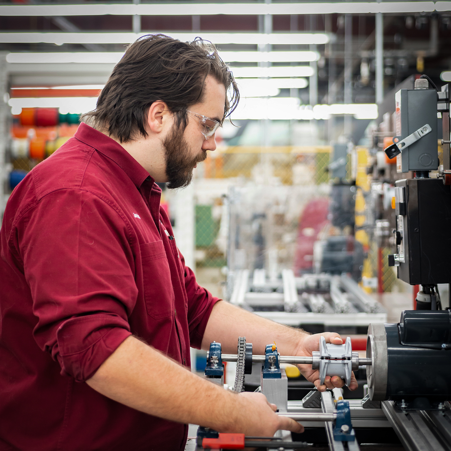 A Rising Scholar Participant working with a machine