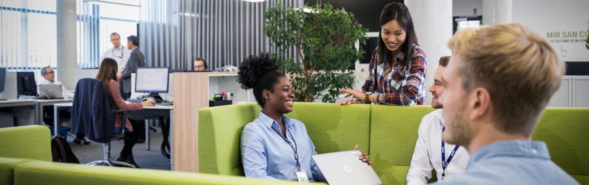A group of students having a conversation in a modern office environment