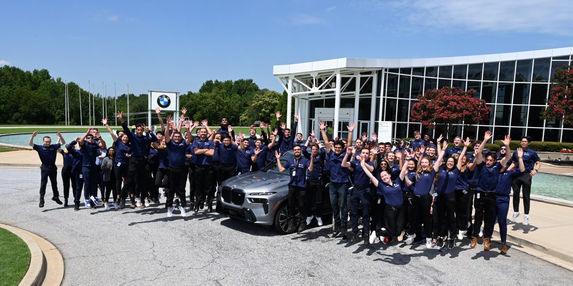 The image shows a group of international interns at the BMW plant in Spartanburg.