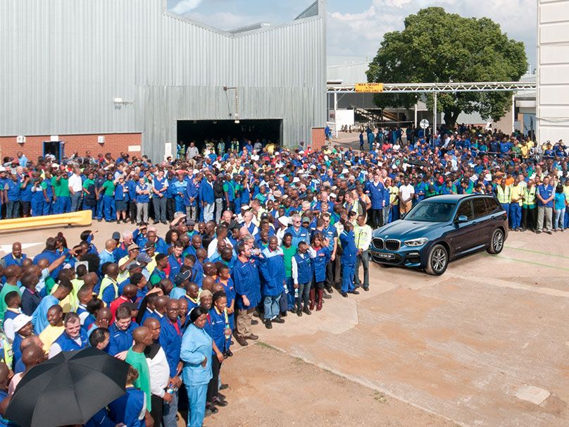 The picture shows a large group of BMW Group employees outside at a BMW plant in South Africa.