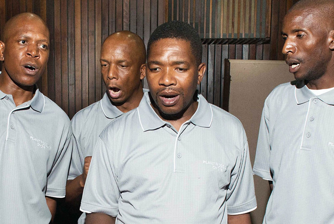 Four men singing in a choir